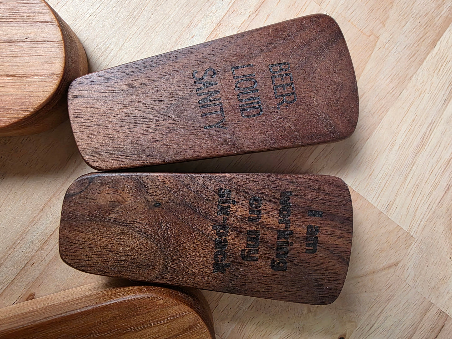 Wooden blocks with engraved text on a wooden surface