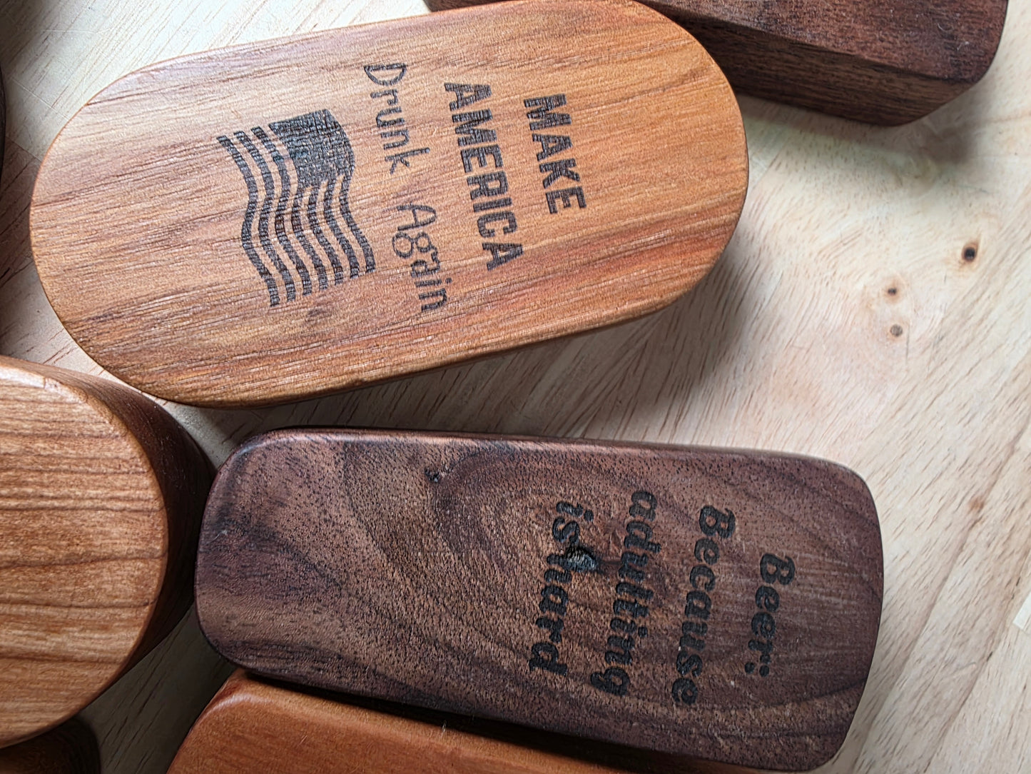 Wooden blocks with engraved text on a wooden surface
