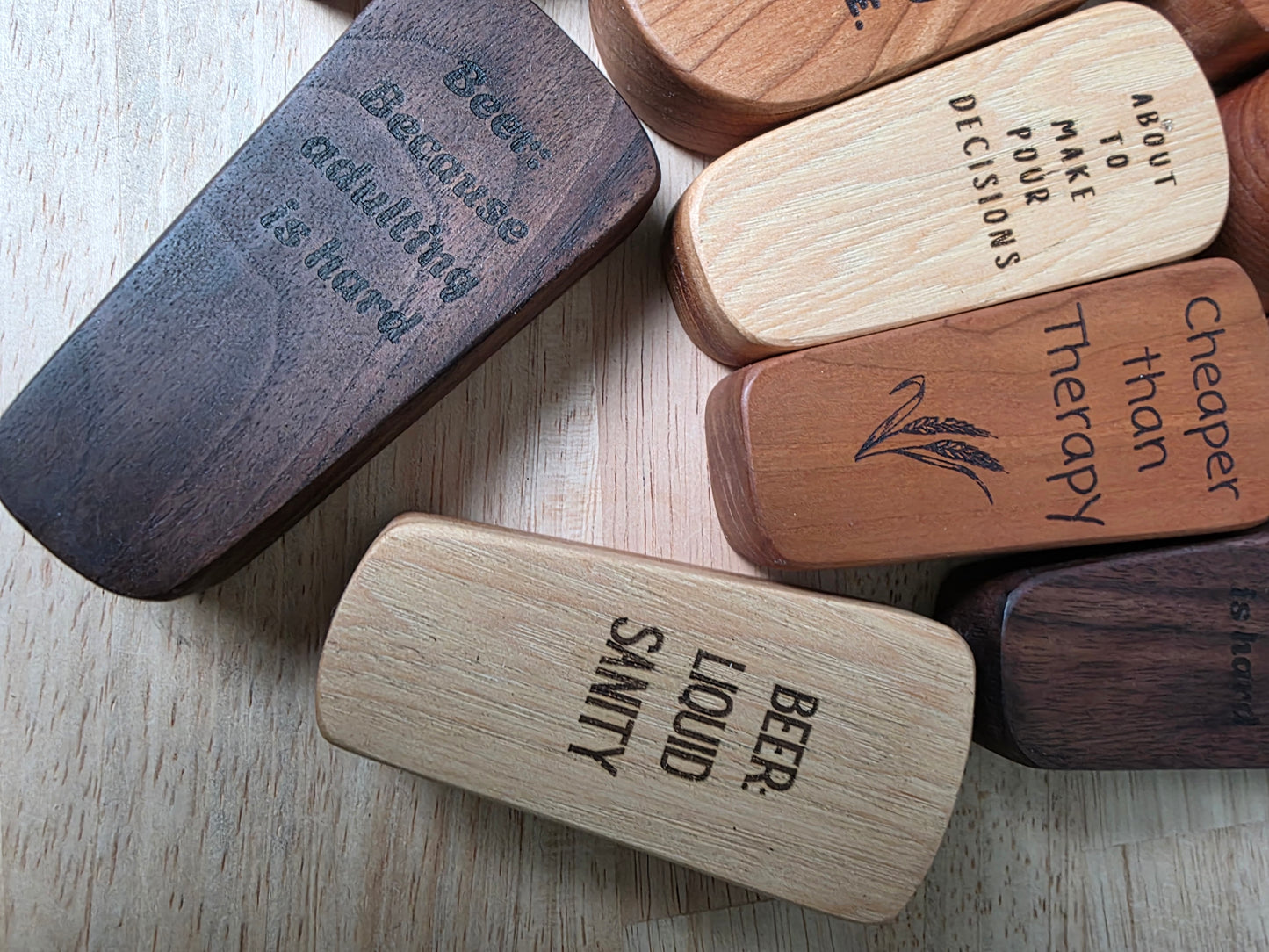 Wooden coasters with engraved text on a wooden surface
