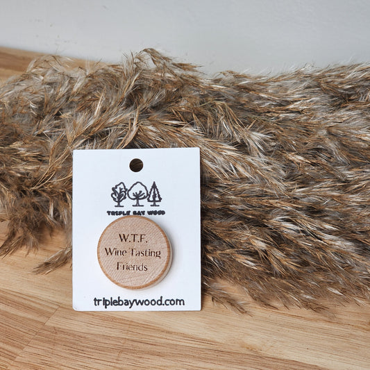 A wooden wine stopper with the inscription 'W.T.F. - Wine Tasting Friends'
