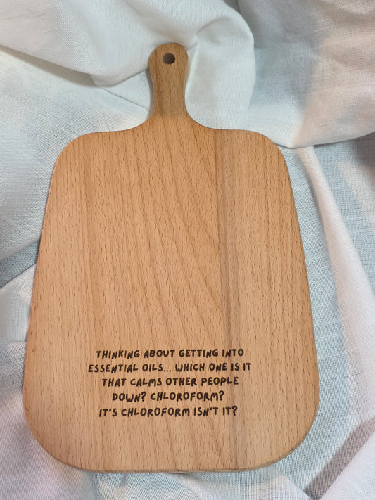 Wooden paddle with engraved text on a light fabric background